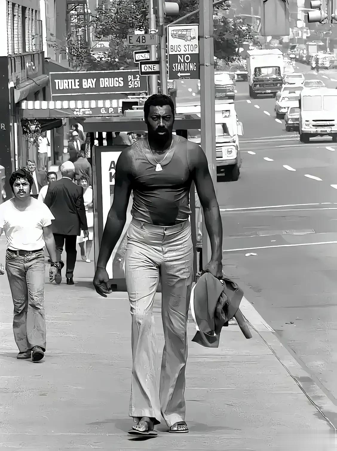 这张照片拍摄于上世纪70年代，美国纽约，威尔特·张伯伦走在大街上，他魁梧的身材有